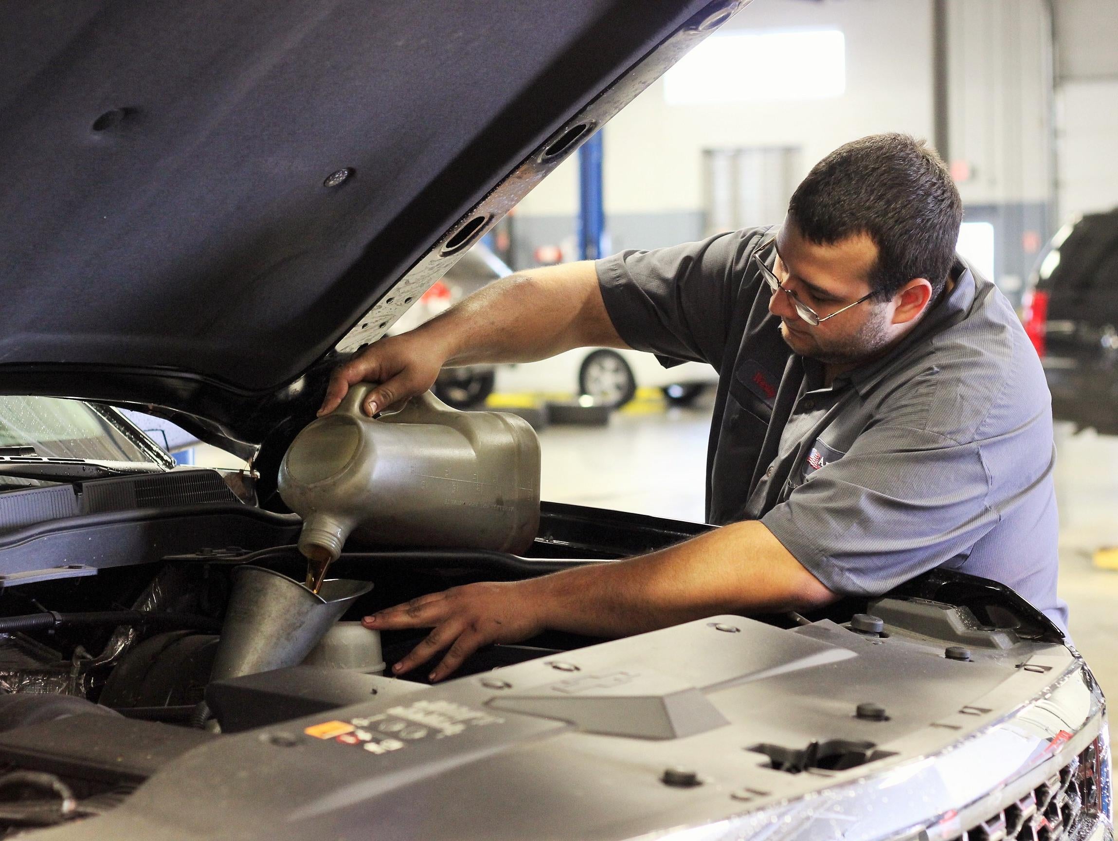 image of a man working on a car
